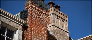 Brick and stone chimneys on a historic building (illustrative photograph)